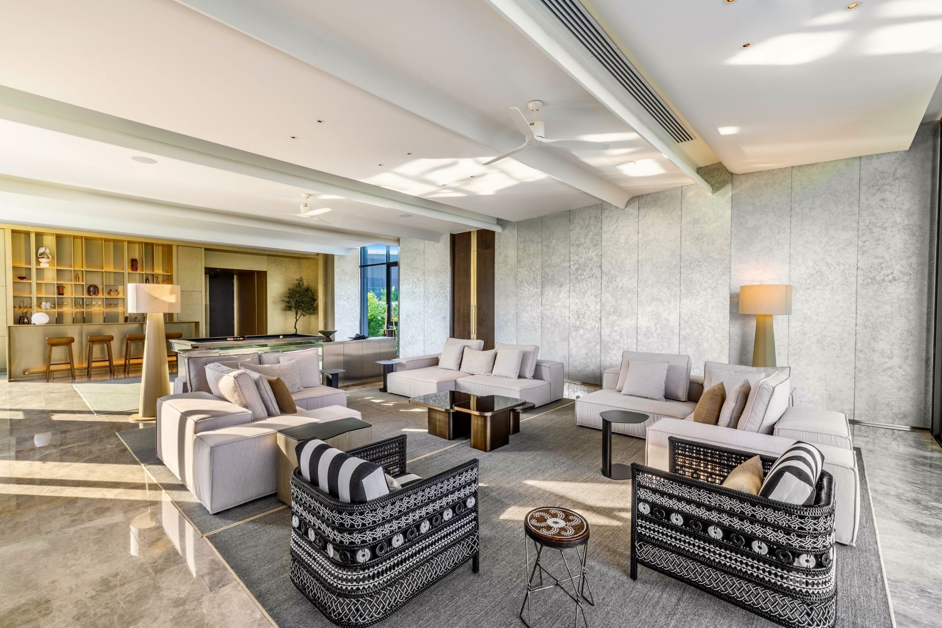 A spacious living area with a pool table, sofas, and a coffee table.