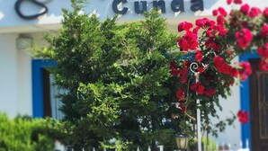 A building with a sign reading "Kaya Korouga Cunda". - KAYA KORUĞU CUNDA (Ayvalik)