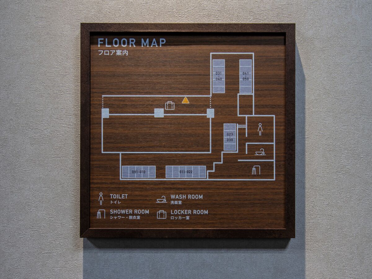 A floor map with labeled rooms including a toilet, washroom, shower room, and locker room.