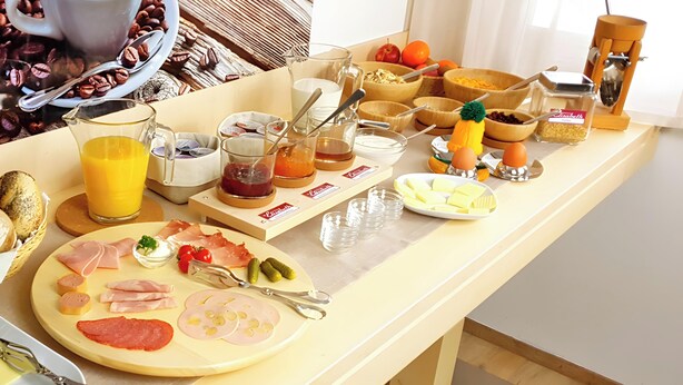 A breakfast buffet with various food items and condiments.