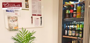 A wall with various notices and a refrigerator stocked with beverages. - Pension Elisabeth Two-Room Double Room No. 4 with Breakfast Included (Todtnau)
