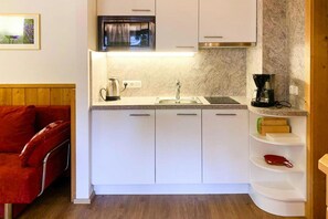 A compact kitchen with a microwave, sink, and coffee maker. - Chalet in Königsleiten near Ski Slopes (Königsleiten)