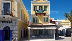 A building with a sign reading "TRAPEZA" and a balcony with a sign for "J. G. G. G. G. G. G. G. G. G. G. G. G. G. G. G. G. G. G. G. G. G. G. G. G. G. G. G. G. G. G. G. G. G. G. G. G. G. G. G. G. G. G. G. G. G. G. G. G. G. G. G. G. G. G. G. G. G. G. G. G. G. G. G. G. G. G. G. G. G. G. G. G. G. G. G. G. G. G. G. G. G. G. G. G. G. G. G. G.