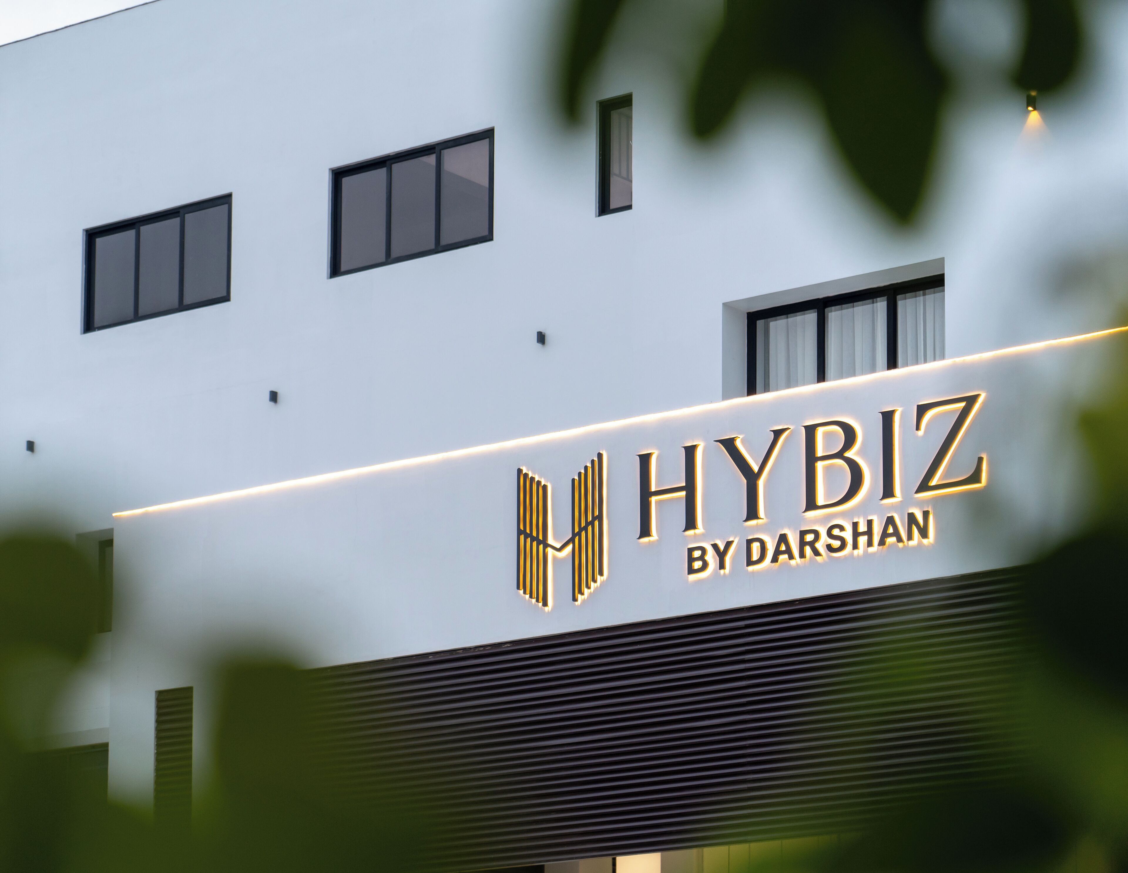 A building with a sign that reads "HYBIZ BY DARSHAN".