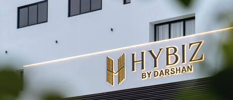 A building with a sign that reads "HYBIZ BY DARSHAN".