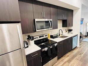 Microwave, stovetop, dishwasher, coffee/tea maker