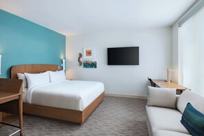 A modern hotel room with a large bed, a sofa, a desk, and a flat-screen TV. - Element by Marriott Las Vegas Symphony Park (Las Vegas)