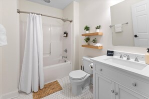 Shower, hair dryer, towels, shampoo