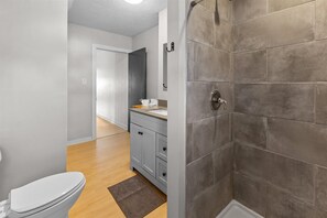Shower, hair dryer, towels, shampoo