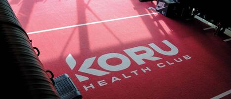 A red carpet with the text "Koru Health Club" on it.