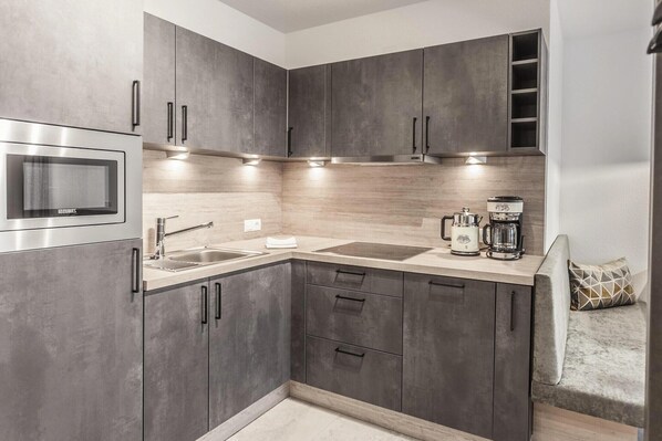 Fridge, stovetop, dishwasher, coffee/tea maker