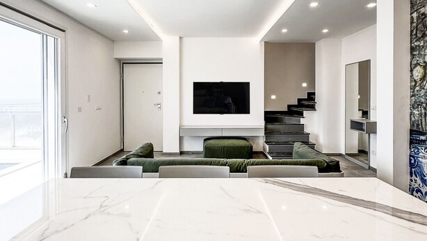 A modern living room with a marble floor, a sofa, a TV, and a staircase. - Orizzonti Blu Pool Villa by Wonderful Italy (Cervo)