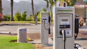 Electric vehicle charging stations with a QR code and a label indicating 'PORT 2'.