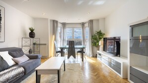 A modern living room with a sofa, coffee table, and TV.