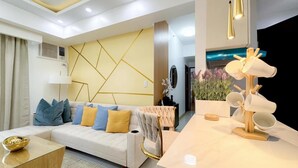 A modern living room with a sofa, coffee table, and a decorative lamp.