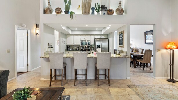 A spacious open-plan living area with a kitchen, dining area, and a cozy seating space.