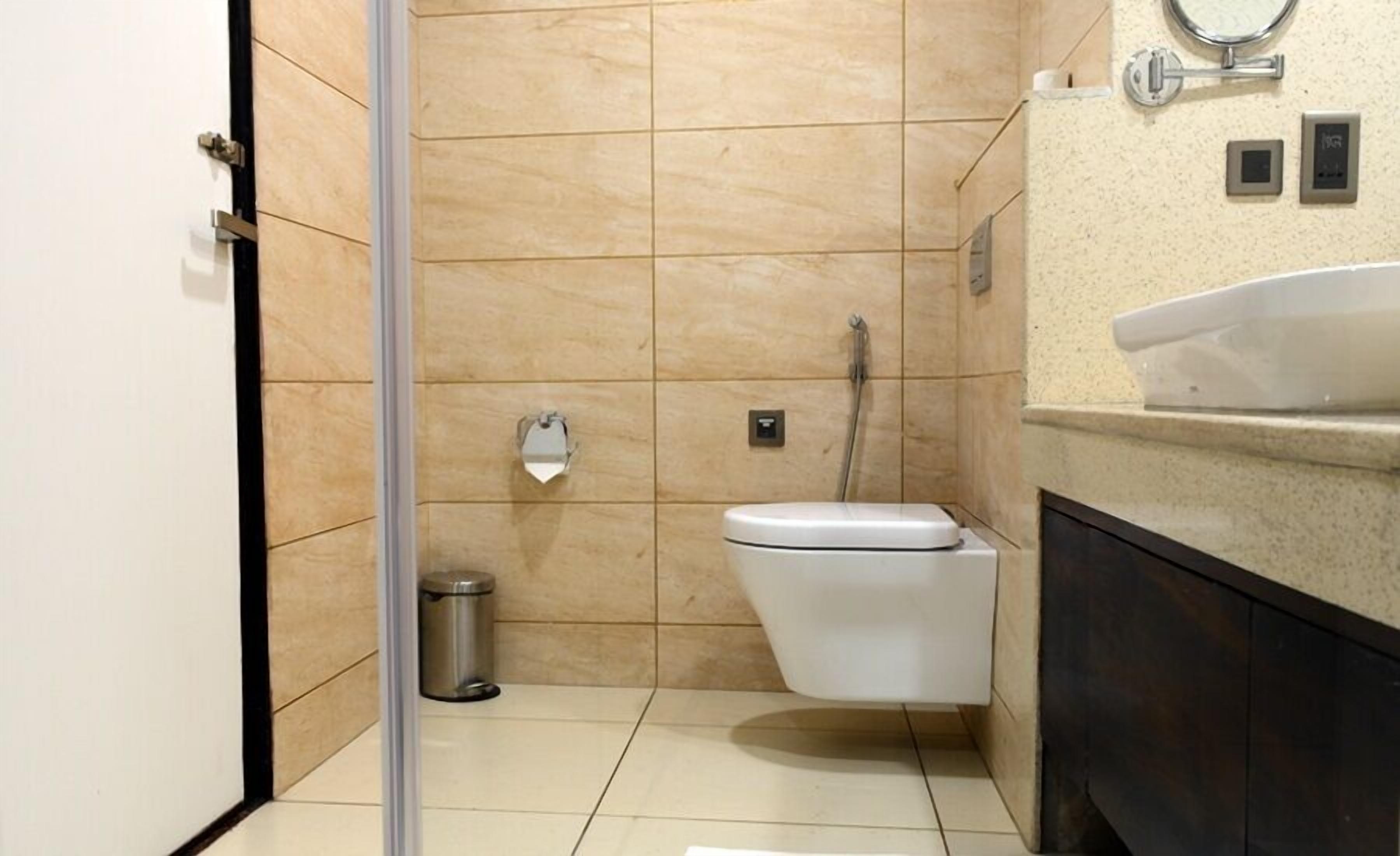 A modern bathroom with a toilet, bidet, and a sink.