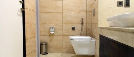 A modern bathroom with a toilet, bidet, and a sink.