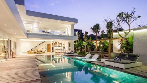 A modern house with a swimming pool, outdoor seating, and a two-story structure. - Niko 2 R New Villa Close to Finns Beach Club (Canggu)