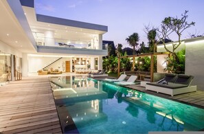 A modern house with a swimming pool, outdoor seating, and a two-story structure. - Niko 2 R New Villa Close to Finns Beach Club (Canggu)