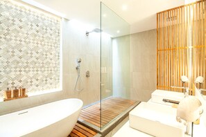 A modern bathroom with a freestanding bathtub, a glass-enclosed shower, and a wooden vanity. - Villa Dayu in Dalung (Tibubeneng)