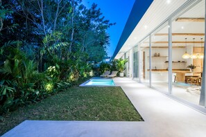 A modern house with a swimming pool, glass doors, and a well-maintained garden. - ULU 4- 2 Br Villa in Pecatu (Pecatu)