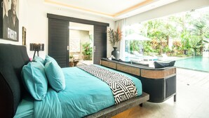 A modern bedroom with a large bed, a view of a swimming pool, and a balcony with plants. - Mette 3br Villa in Dalung (Canggu)