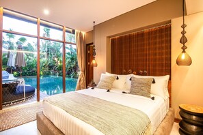 A bedroom with a large bed, a view of a swimming pool, and a wooden headboard. - Villa Na in Canggu With 6 Bedrooms and 6 5 Bathrooms (Tibubeneng)