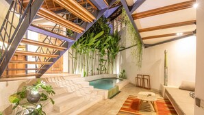 Un interior moderno con piscina, escalera y plantas de interior.