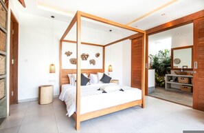 A modern bedroom with a four-poster bed, a wooden headboard, and a large mirror. - Canggu Julia 2 in Dalung (Canggu)