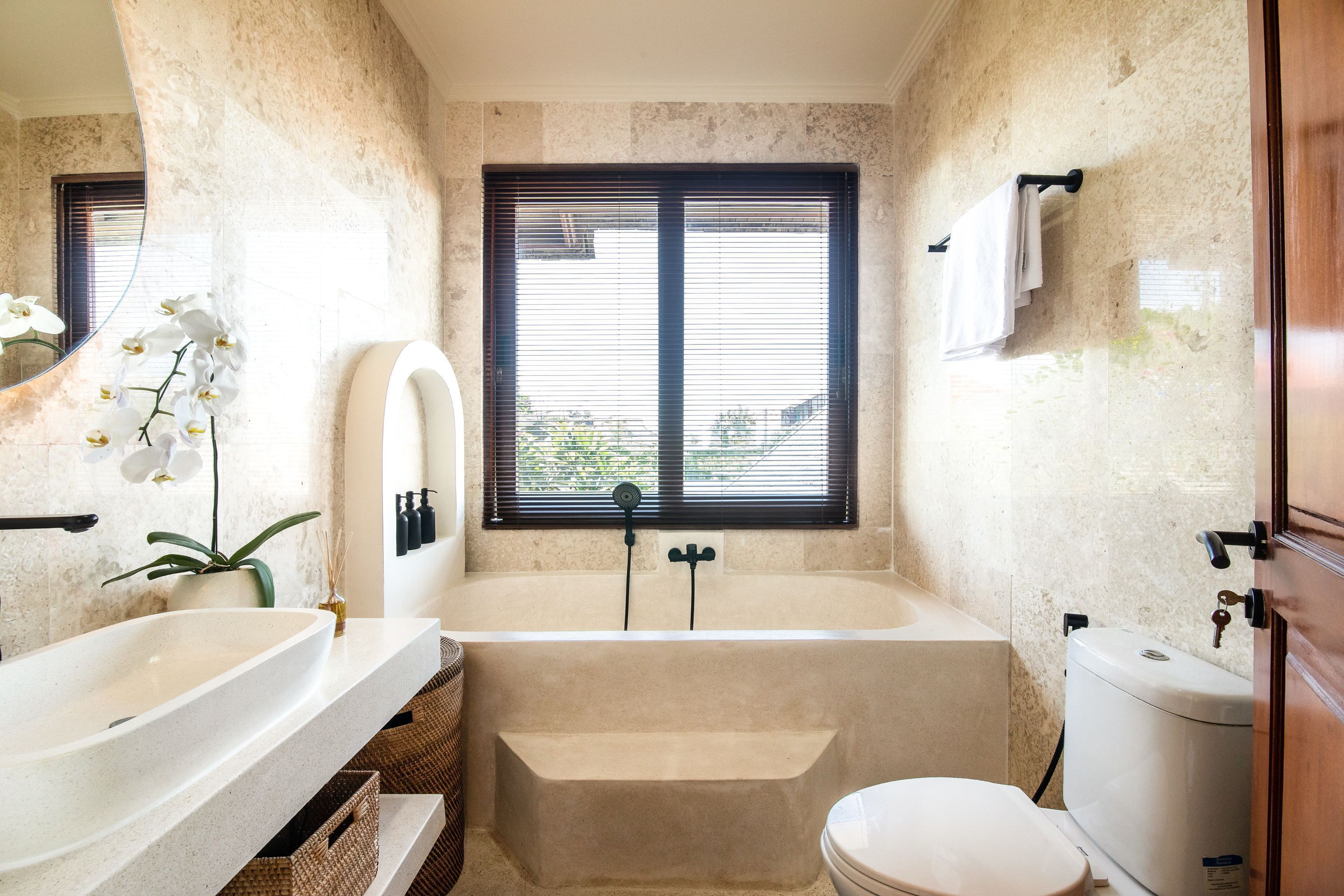 A bathroom with a bathtub, toilet, and sink.