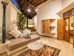 A spacious living area with a sofa, coffee table, and a large wooden cabinet. - BA Villa 4 1BR Lush 1-br Villa With Pool 4 Mins to Echo Beach (Pererenan)