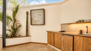 A kitchen with wooden cabinets, a sink, and a countertop.
