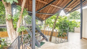 A covered outdoor staircase with metal railings, surrounded by trees and plants. - BA Villa 10 2 BR Stylish 2-br Villa With Pool 800m Canggu Beach (Pererenan)