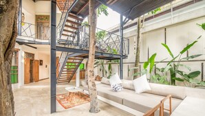 A spacious indoor area with a staircase, a sofa, and a coffee table. - BA Villa 10 2 BR Stylish 2-br Villa With Pool 800m Canggu Beach (Pererenan)