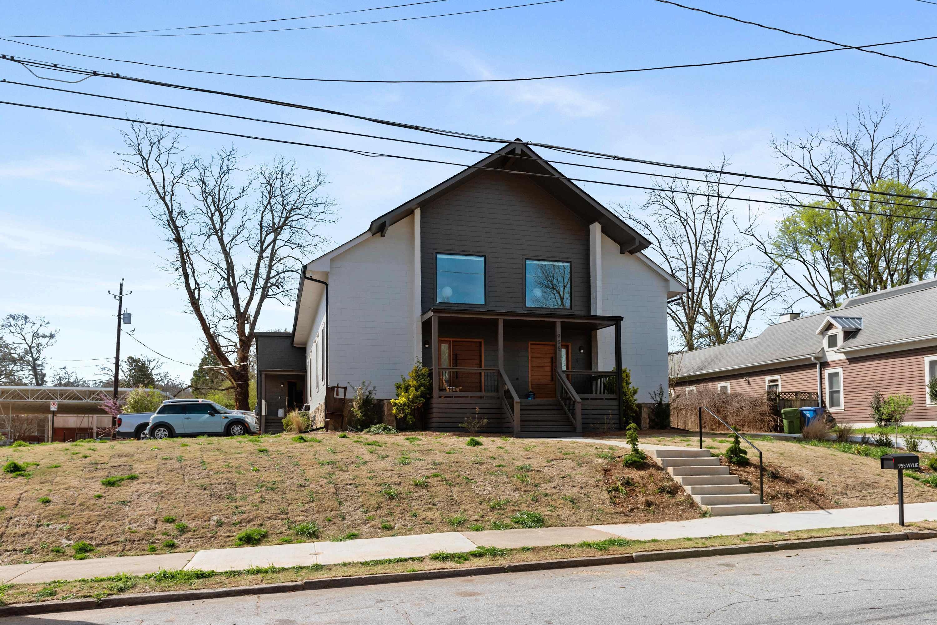 A two-story house with a front porch, a driveway, and a mailbox.