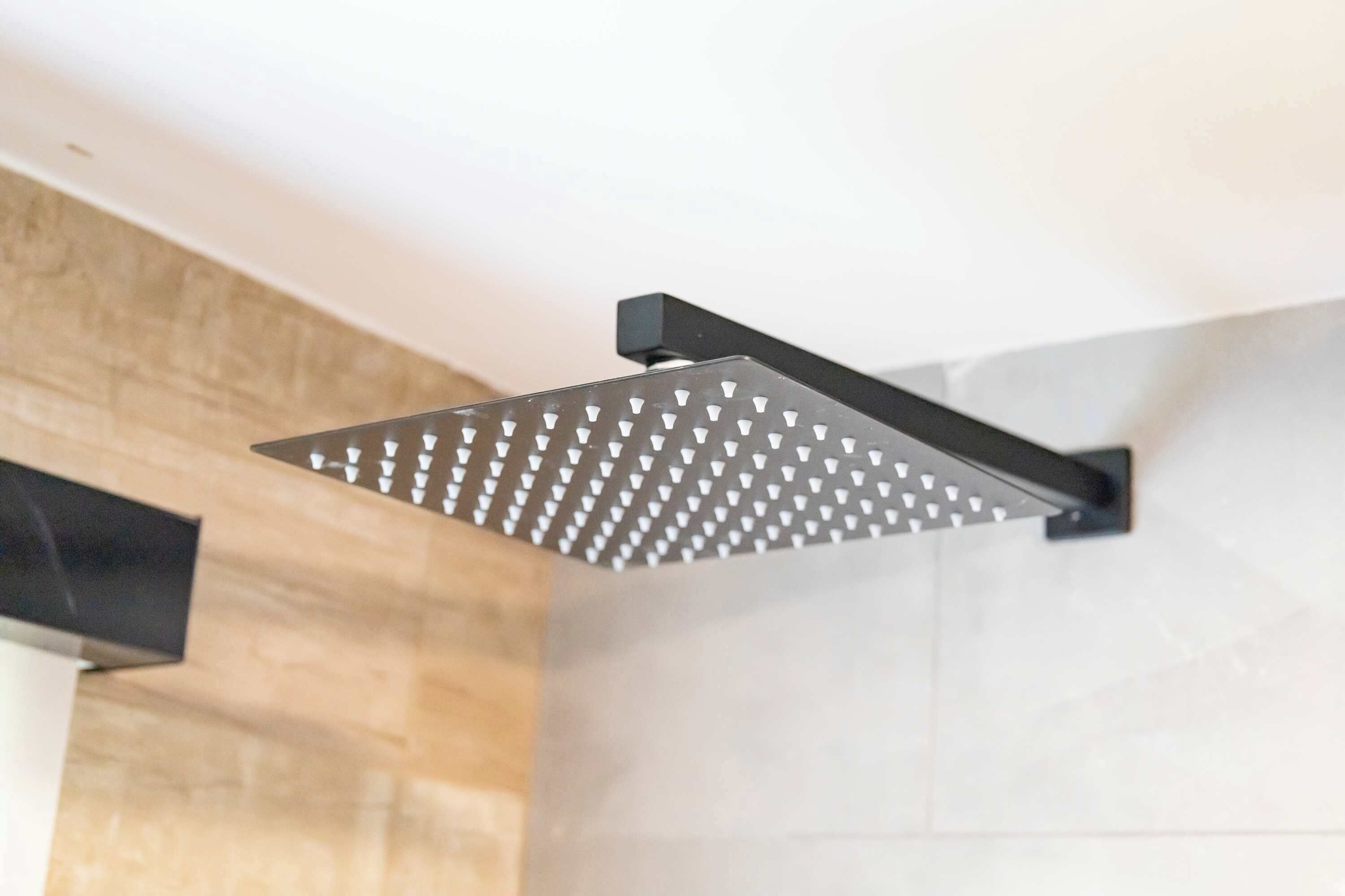 A modern showerhead with a square design and multiple nozzles.