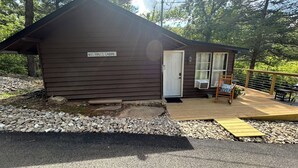 A small cabin labeled "Miss Hall's Cabin" with a wooden deck, a wheelchair-accessible ramp, and a picnic table. - NEW LISTING:Spring River:Creek Cabin, Private Footage on South Fork Spring River (Hardy)