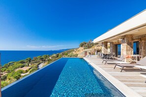 A modern villa with a long swimming pool overlooking a coastal landscape. - Architect Villaproperty Sea View Close to the Beaches (Calcatoggio)