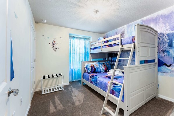A child's bedroom with bunk beds, a radiator, and a window with blue curtains.