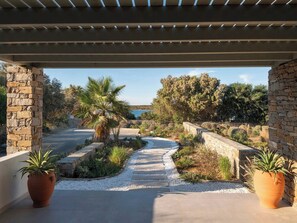 A covered outdoor area with a stone pathway leading to a scenic view.