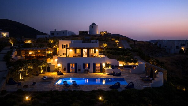 A modern villa with a swimming pool, multiple balconies, and a view of the surrounding landscape. - Villa Tchi Tcha - Naoussa Bay (Kamares Naousas)