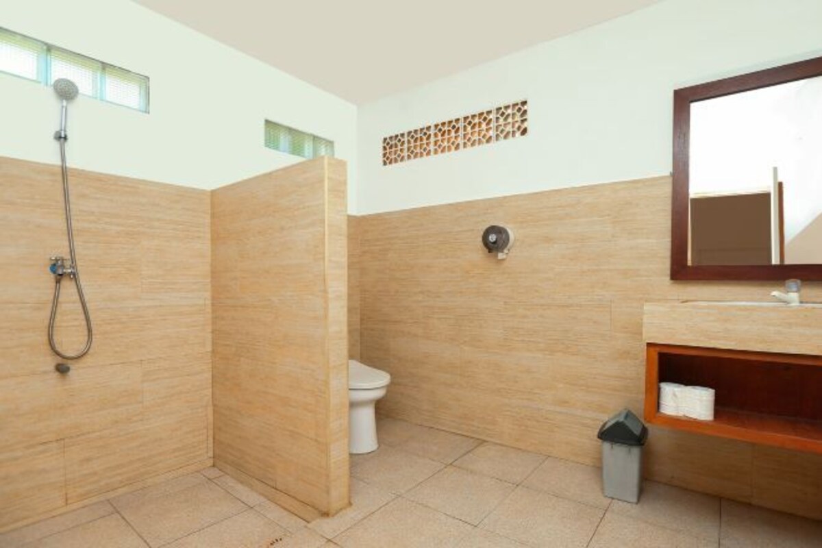 A bathroom with a shower, toilet, and sink.