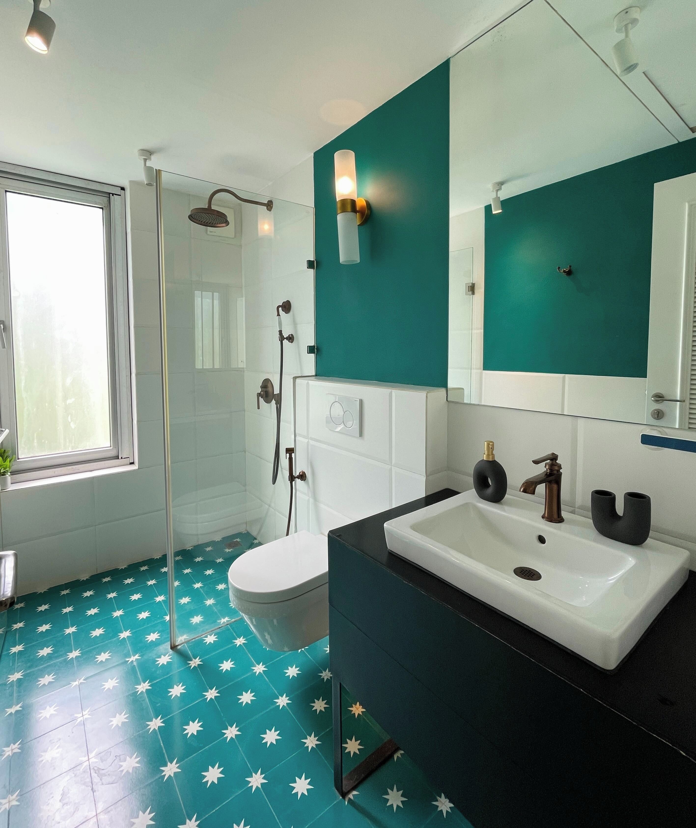 A modern bathroom with a shower, toilet, and sink.