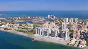A coastal residential area with high-rise buildings, a beach, and a marina. - 2 bedroom apartment / lmb1323 (La Manga Del Mar Menor)
