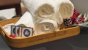 Un plateau avec des serviettes pliées et une pancarte indiquant : « BIENVENUE DANS L’ESPACE ZEN ».