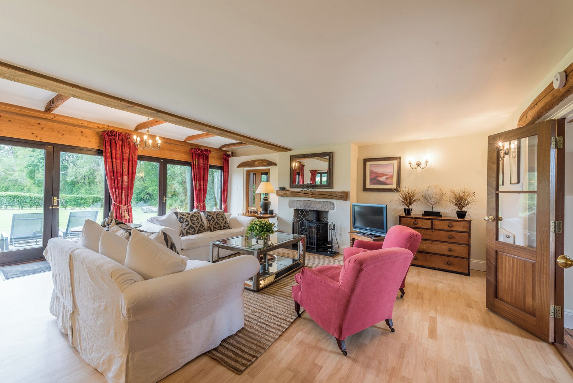 A cozy living room with a fireplace, comfortable seating, and a television.
