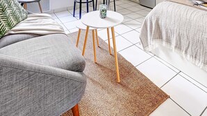 A compact living space with a kitchenette, a dining area, and a sofa. - Charming Studio near Eiffel Tower for 2 (Paris)