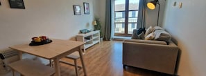 Relax in this inviting space with a comfortable sofa, dining table, and console table.
