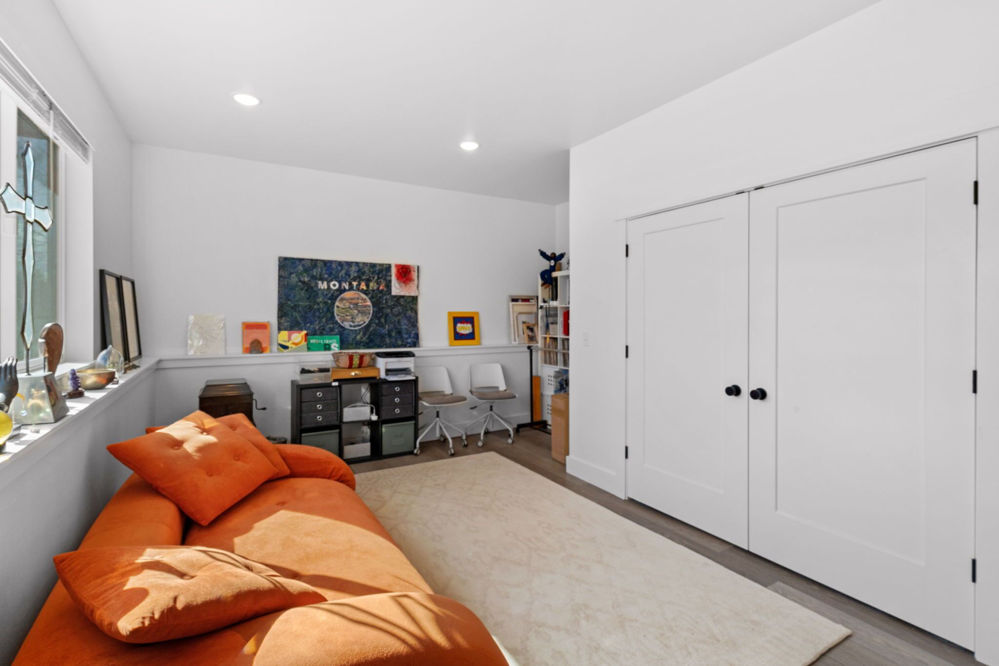 A bedroom with a bed, a desk, and a wardrobe.